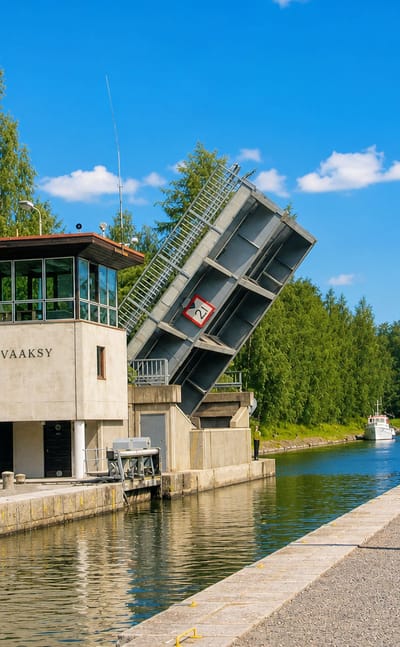 The Vaaksy canal in Asikkala with its raised bascule bridge and boats passing the control tower.