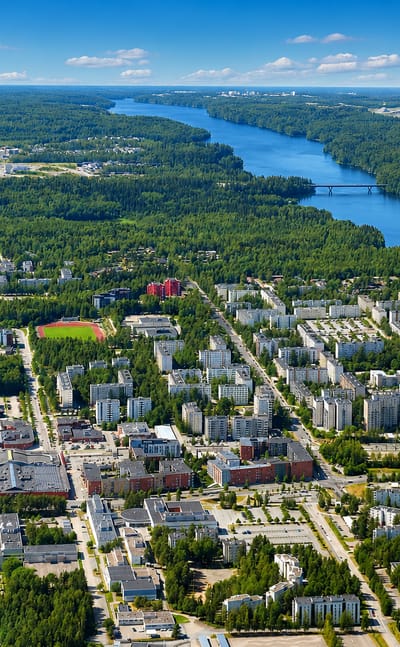 Aerial view of Hervanta, Tampere's dense suburb of apartment blocks ringed by boreal forest and lakes