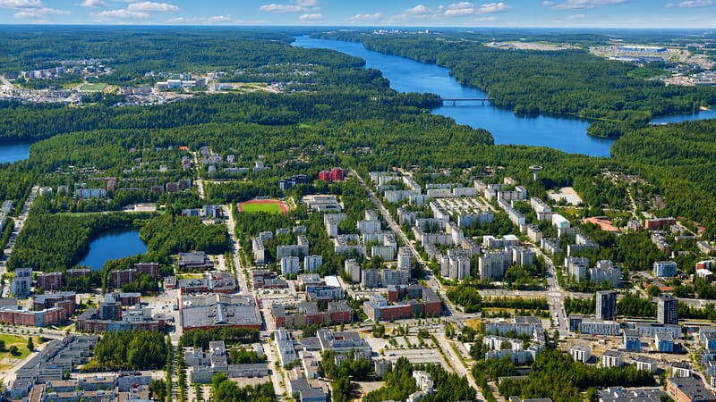 Aerial view of Hervanta, Tampere's dense suburb of apartment blocks ringed by boreal forest and lakes