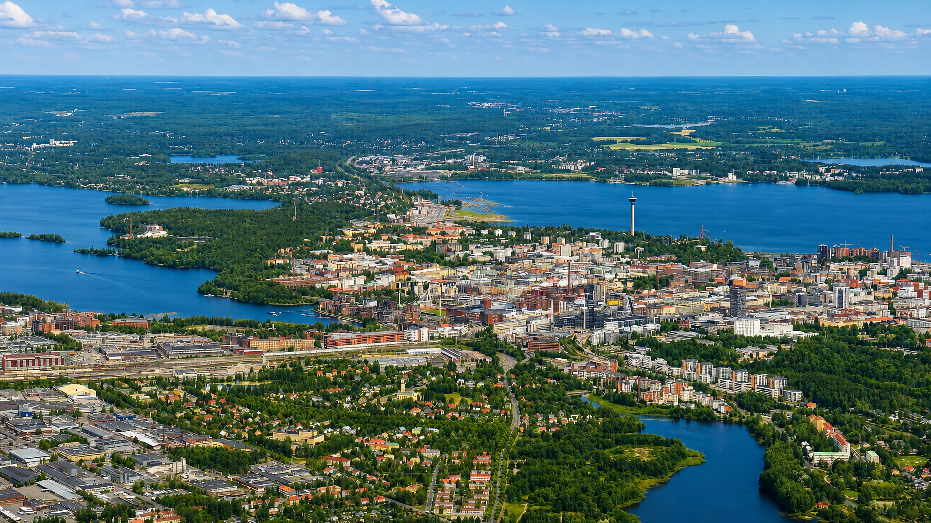 Aerial view of Tampere and the Kalevanharju district between lakes, with the Näsinneula tower on the skyline