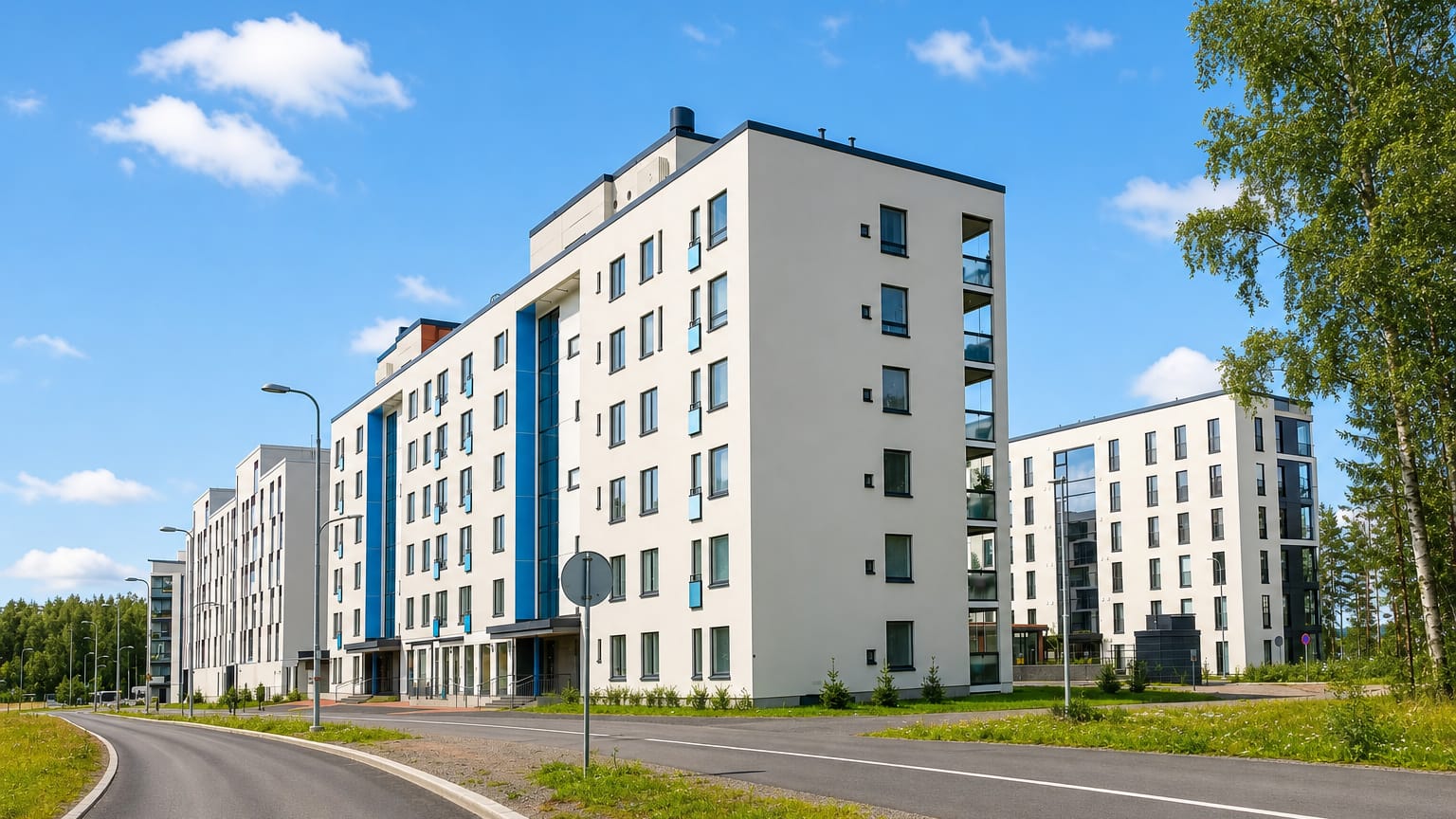 Modern white apartment blocks along a quiet street in Lentavanniemi, a western suburb of Tampere