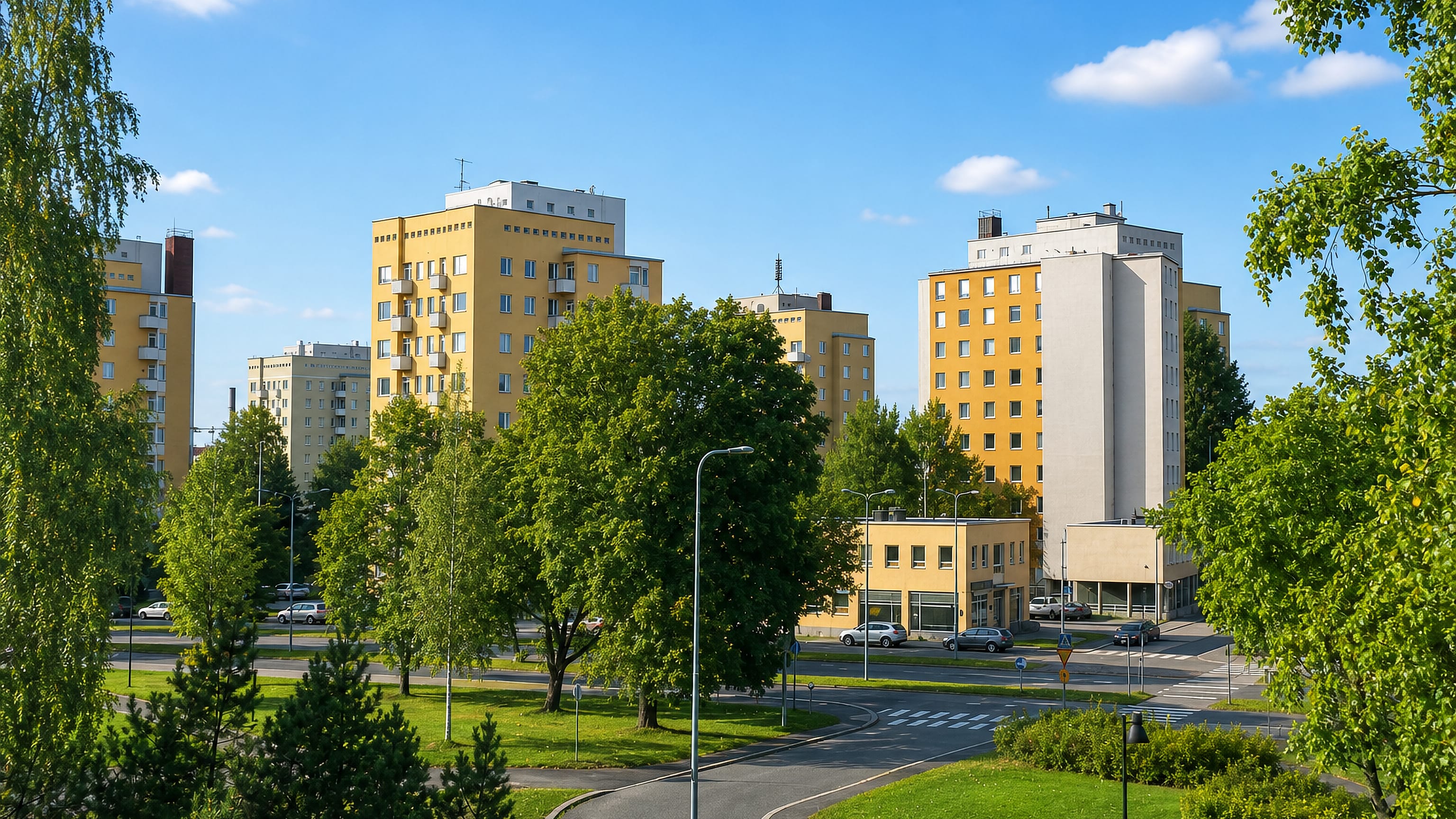 Yellow mid-century apartment blocks among birches and lawns in Liisankallio, Tampere.