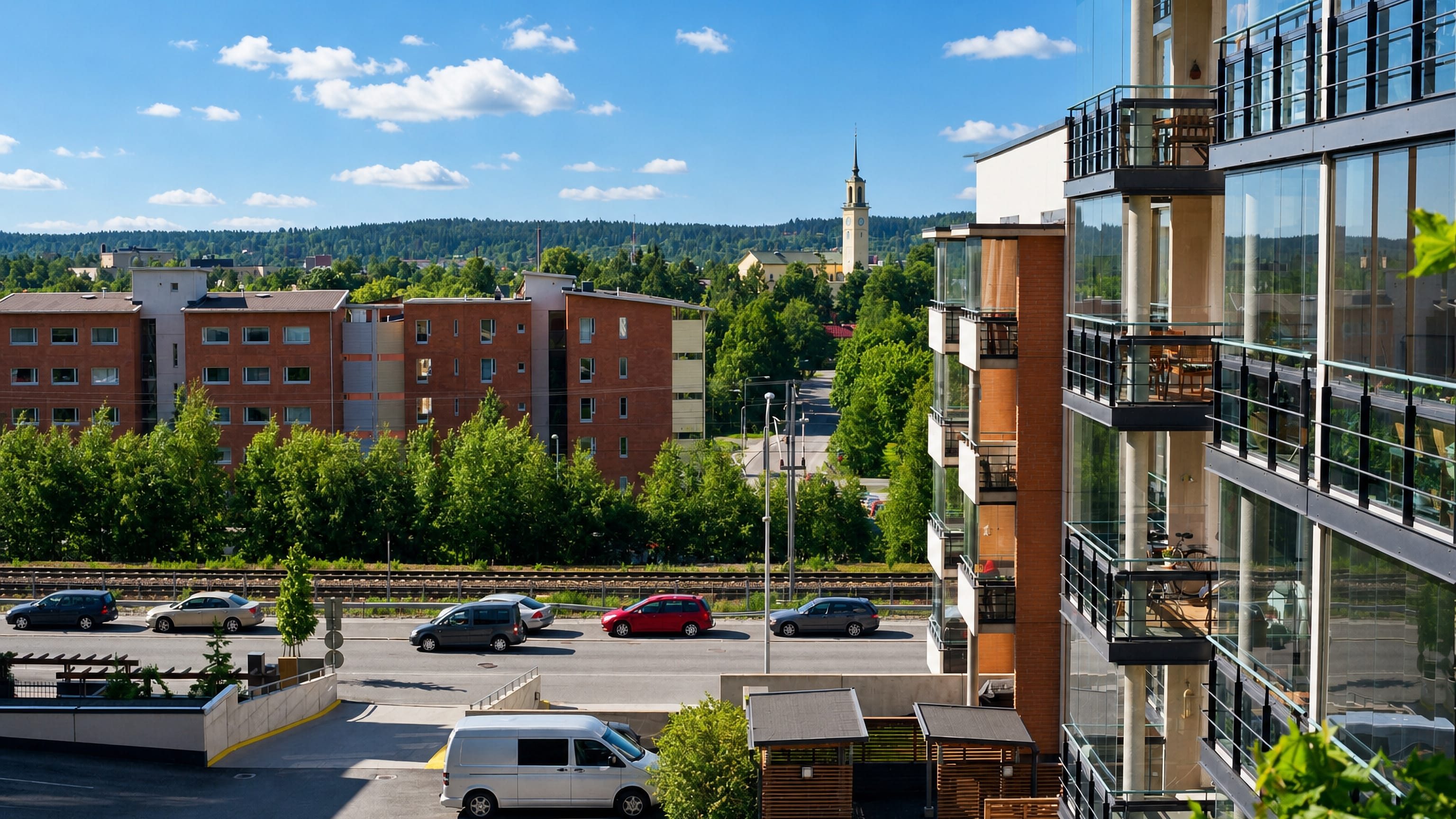 Red-brick apartment blocks, a distant church spire and wooded ridges seen across Viinikka in Tampere.