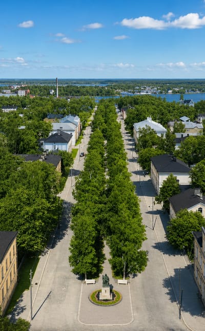 Aerial daytime view of Vaasa, Finland, with a tree-lined esplanade and statue leading toward the Gulf of Bothnia archipelago
