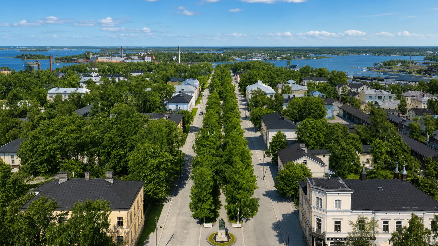 Aerial daytime view of Vaasa, Finland, with a tree-lined esplanade and statue leading toward the Gulf of Bothnia archipelago