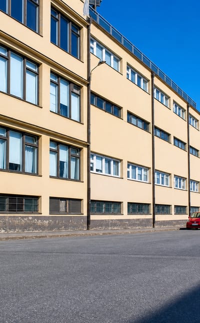 Long yellow functionalist warehouse building lining a street in Klemettilä, a commercial district of Vaasa.
