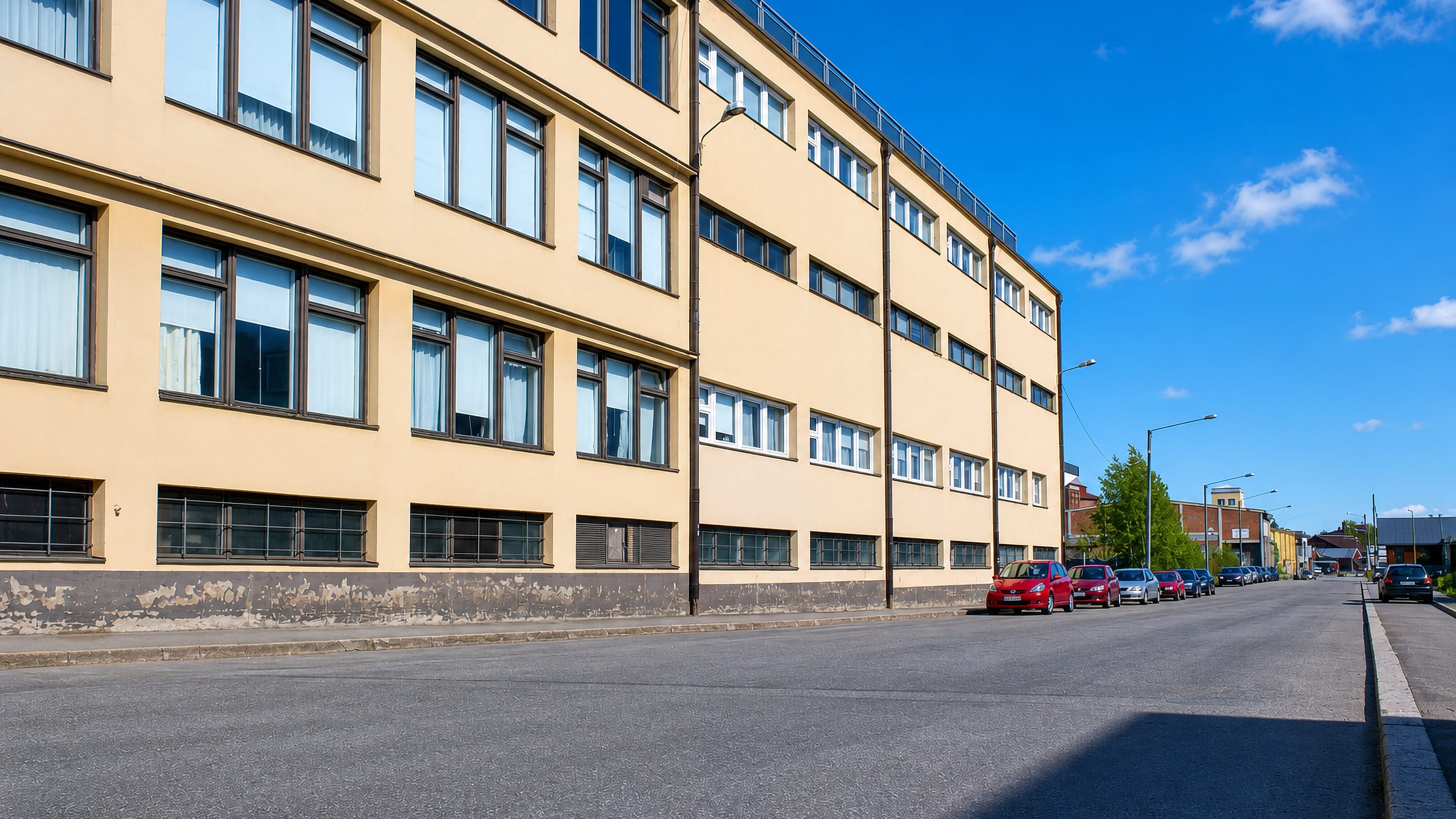 Long yellow functionalist warehouse building lining a street in Klemettilä, a commercial district of Vaasa.