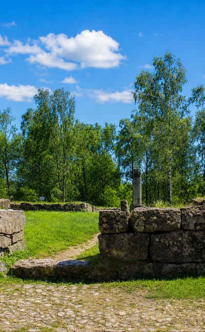 Stone ruins and cobbled paths among birches at Vanha Vaasa, the old town site of Vaasa in Finland.