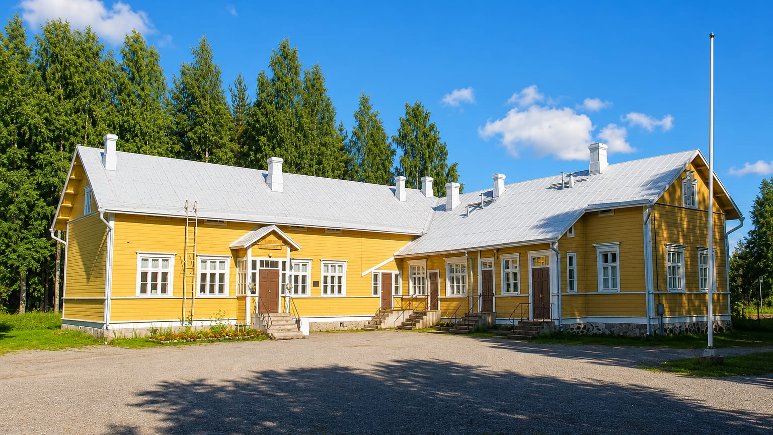 Yellow timber building with a metal roof beside spruce woods in Utra, Joensuu.