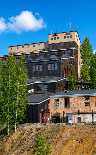 Outokumpu's Old Mine museum, its timber headframe and red-brick works rising on a hill among birches