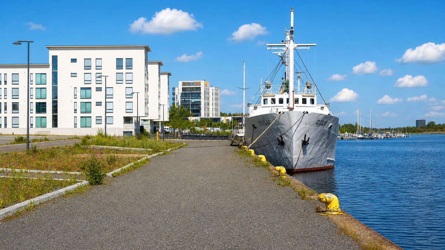 The vessel Oulu moored at the quay below new white apartment blocks in Toppilansaari, Oulu.