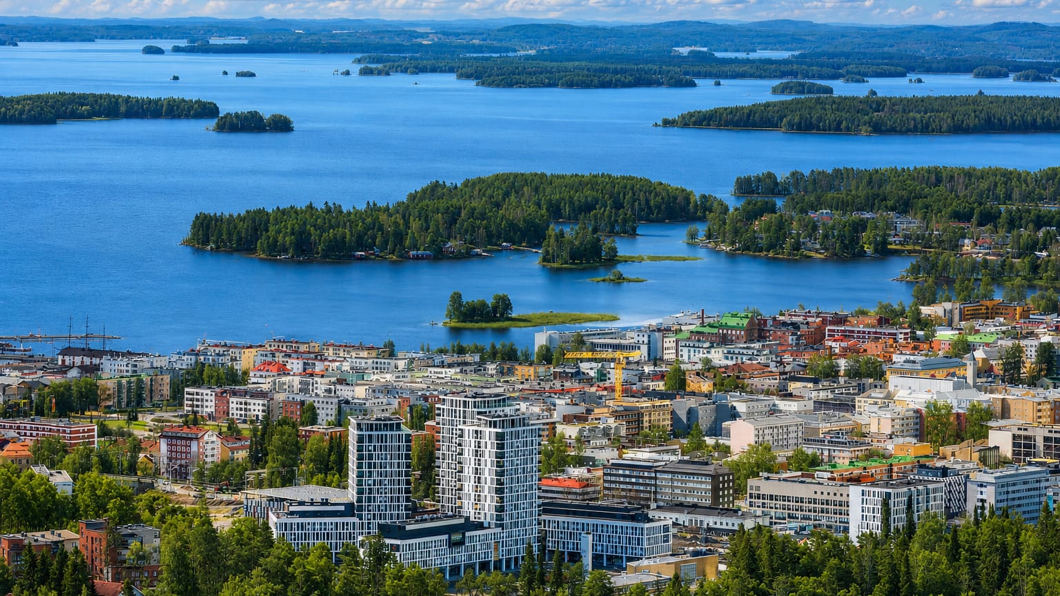 Aerial summer view over Kuopio, Finland, with its lakeside downtown and the forested islands of Lake Kallavesi beyond.