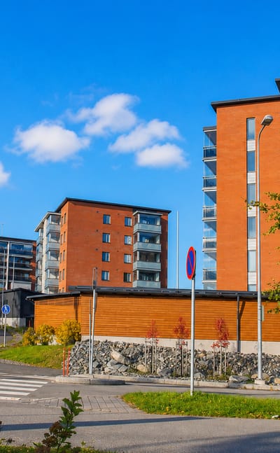 Modern brick and render apartment blocks along a new street in Lehtoniemi, Kuopio.