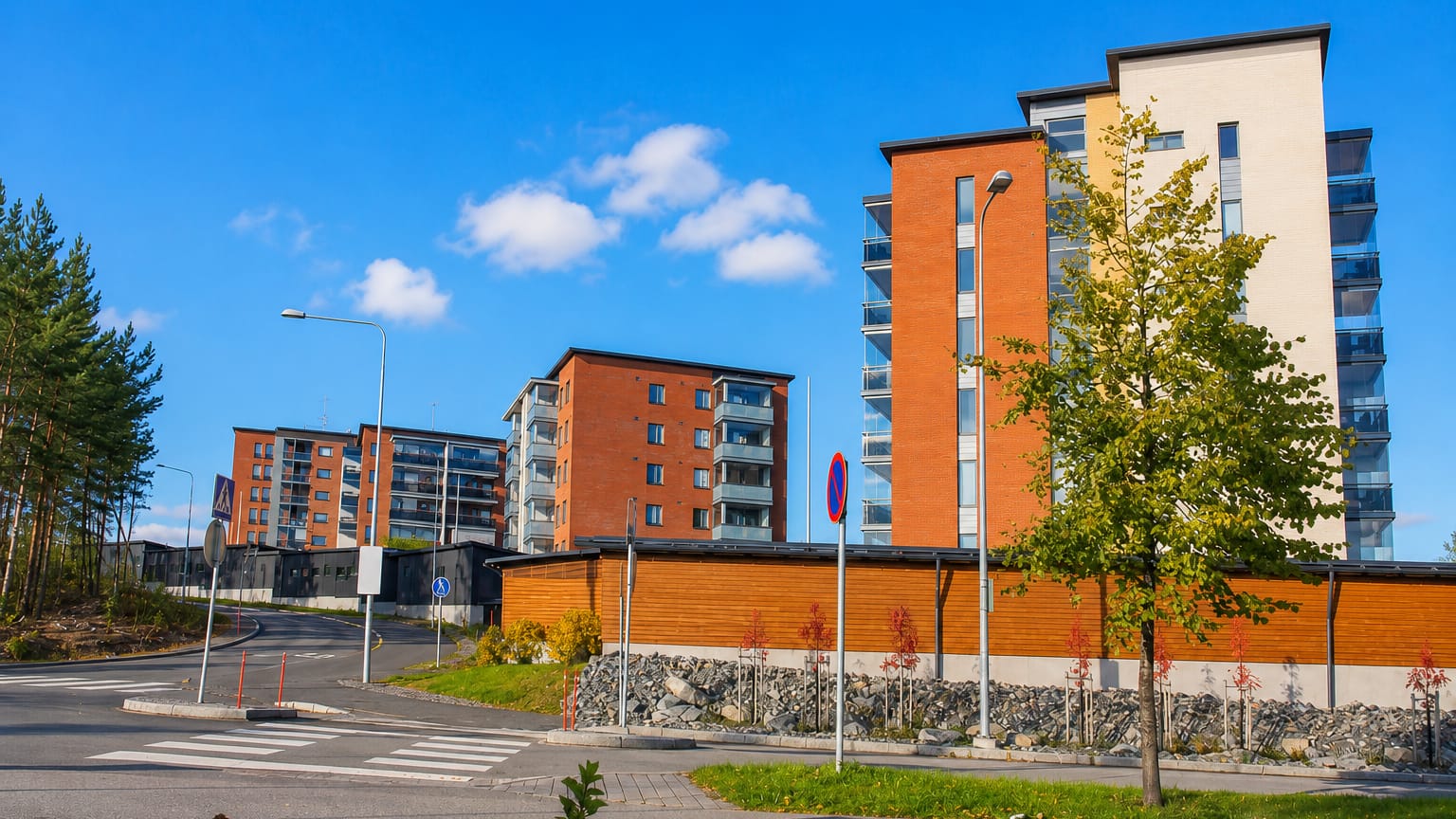 Modern brick and render apartment blocks along a new street in Lehtoniemi, Kuopio.