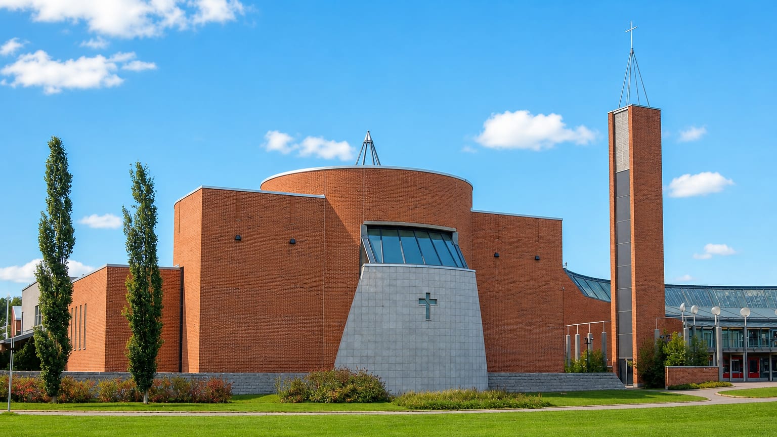 Modern red-brick church with a tall bell tower and open lawns in Sammonlahti, Lappeenranta.