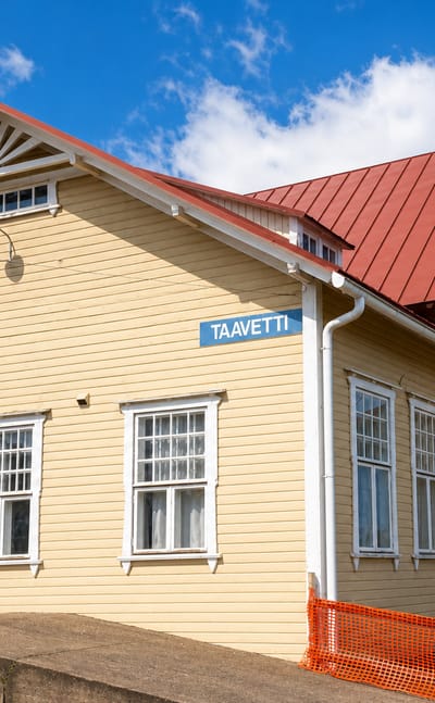 Taavetti's yellow wooden railway station with a red roof and its clear TAAVETTI nameboard.