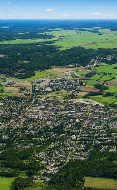 Aerial view of Kurikka, Finland, a small town spread among green fields and forests in South Ostrobothnia.