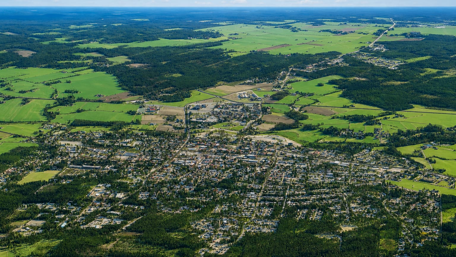 Aerial view of Kurikka, Finland, a small town spread among green fields and forests in South Ostrobothnia.