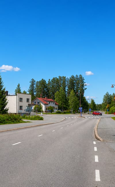 A quiet main road lined with lampposts and houses through the rural centre of Soini, South Ostrobothnia.
