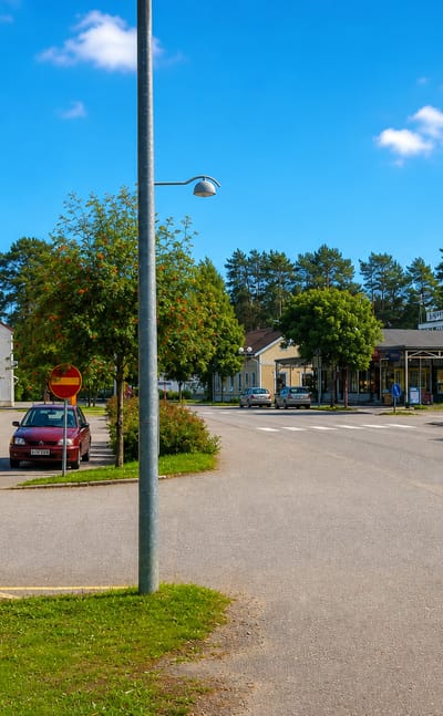 Small-town grocery store and quiet street corner in Rantasalmi, Finland on a summer day.