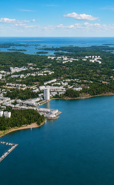 Aerial of Espoo's coastal suburb with apartment blocks, a marina and the surrounding archipelago