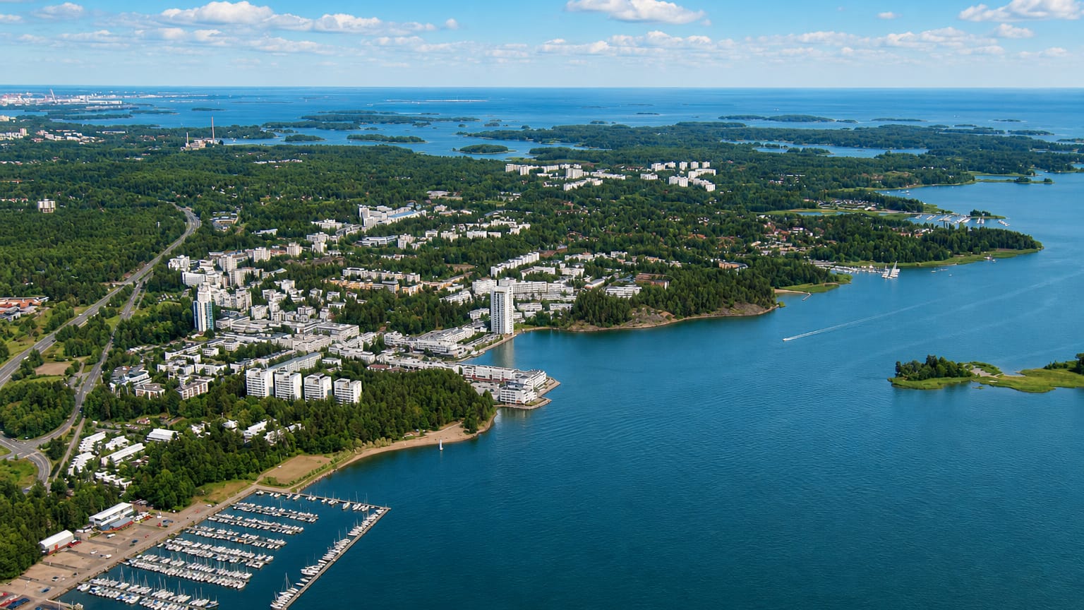 Aerial of Espoo's coastal suburb with apartment blocks, a marina and the surrounding archipelago