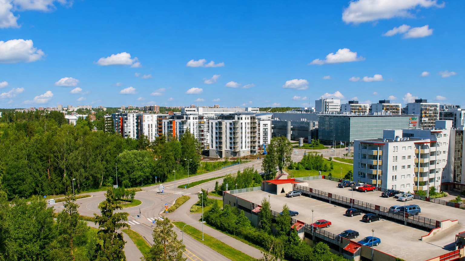 Aerial daytime view of Matinkylä, Espoo, with modern white apartment blocks set among forest and suburban roads