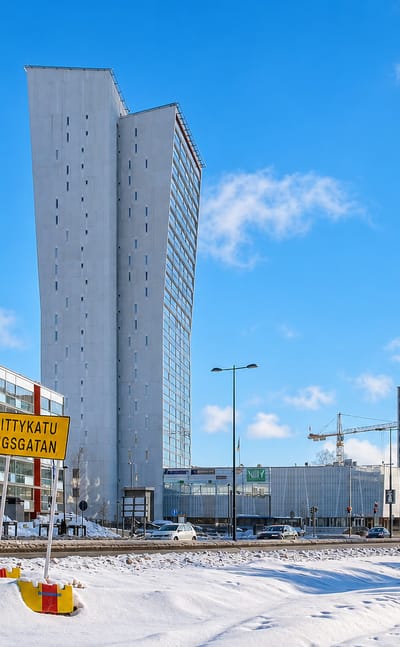 Niittykumpu, Espoo, Finland: the slim white Niittyhuippu tower above snowy streets and a Niittykatu street sign.