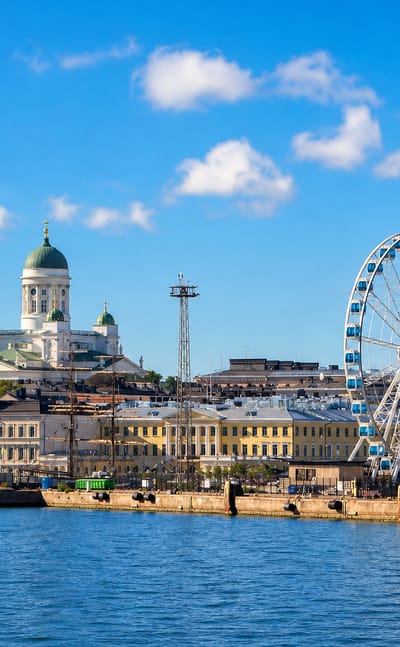 Helsinki harbour with the domed Cathedral and the SkyWheel Helsinki ferris wheel above the market quay