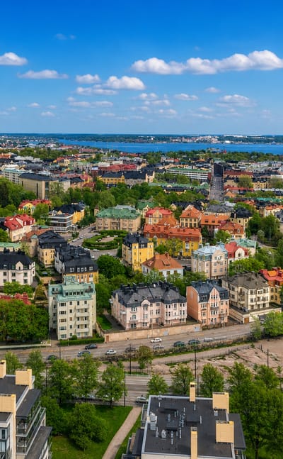 Aerial view over Eira in Helsinki, its Art Nouveau villas and church spire framed by the Baltic seafront.