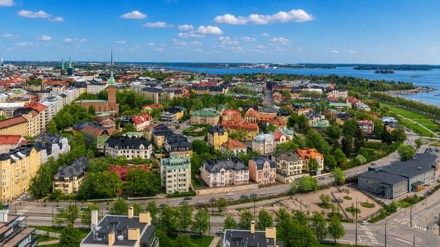 Aerial view over Eira in Helsinki, its Art Nouveau villas and church spire framed by the Baltic seafront.