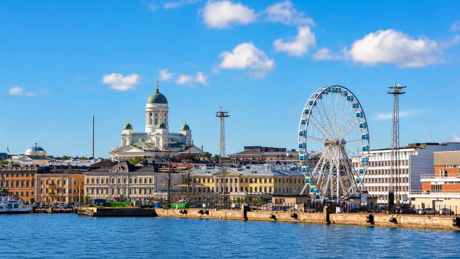 Helsinki harbour with the domed Cathedral and the SkyWheel Helsinki ferris wheel above the market quay