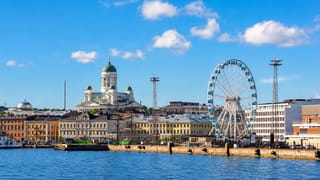Helsinki harbour with the domed Cathedral and the SkyWheel Helsinki ferris wheel above the market quay