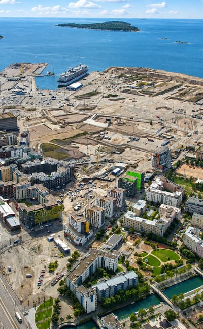 Aerial view of Jätkäsaari, Helsinki, with West Harbour ferries, new waterfront housing blocks and ongoing construction.
