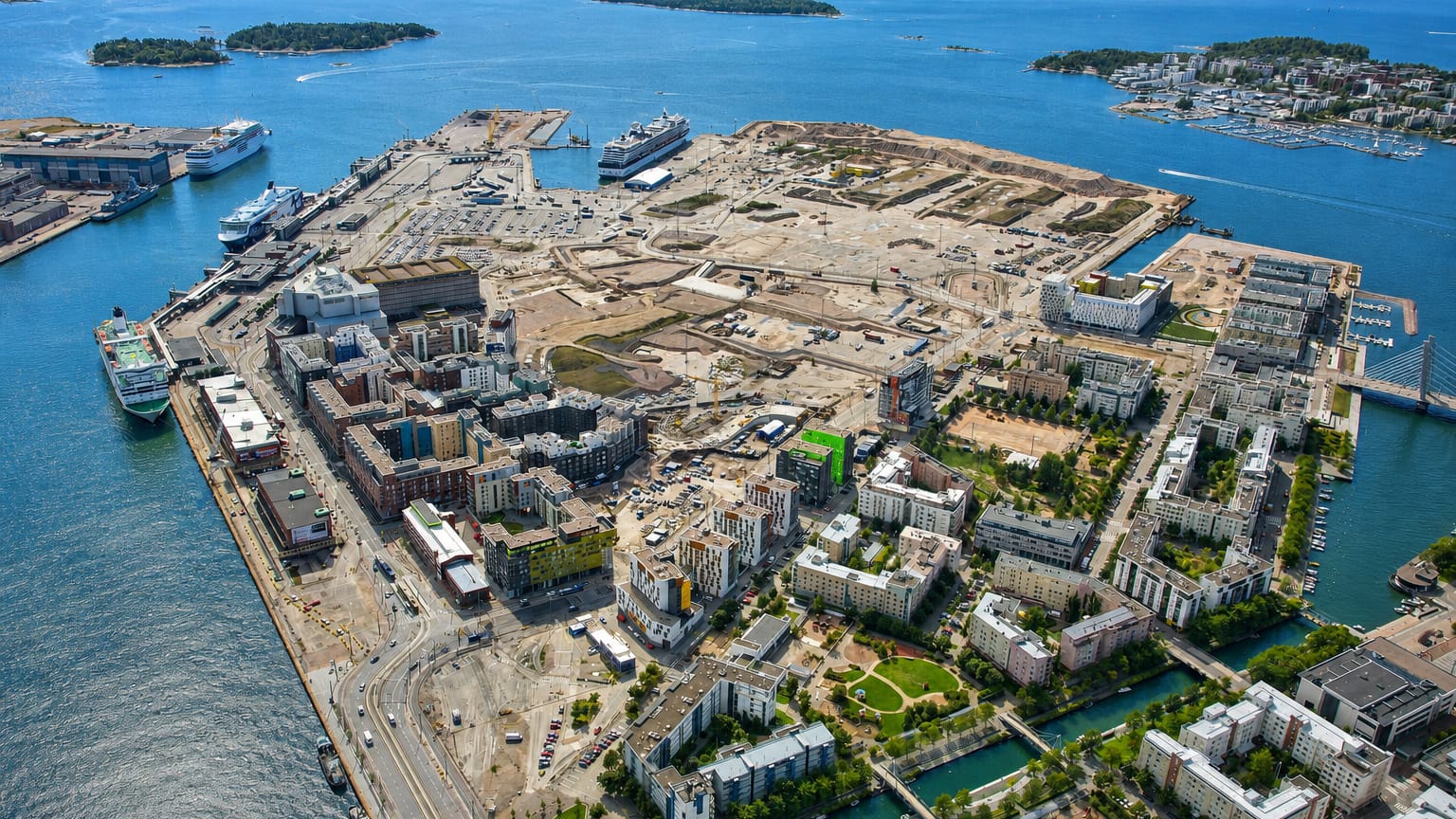 Aerial view of Jätkäsaari, Helsinki, with West Harbour ferries, new waterfront housing blocks and ongoing construction.