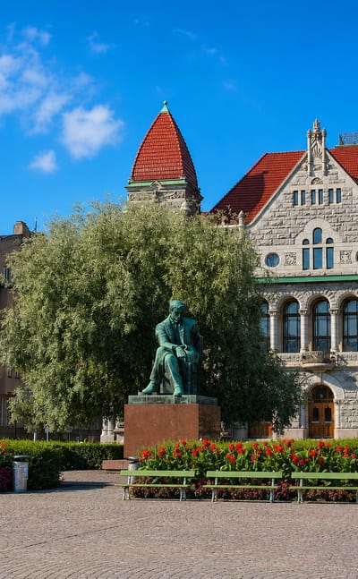 The Finnish National Theatre and Aleksis Kivi statue on the square beside Kaisaniemi in central Helsinki.