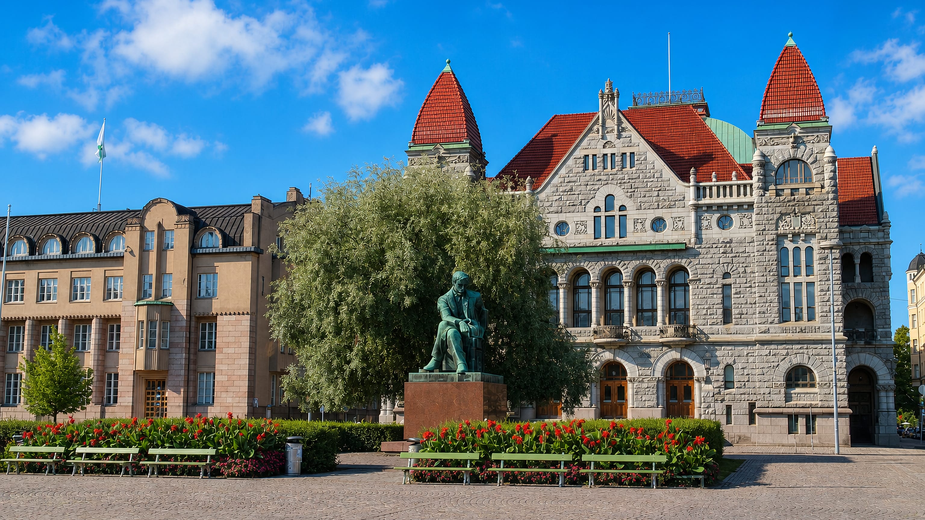 The Finnish National Theatre and Aleksis Kivi statue on the square beside Kaisaniemi in central Helsinki.