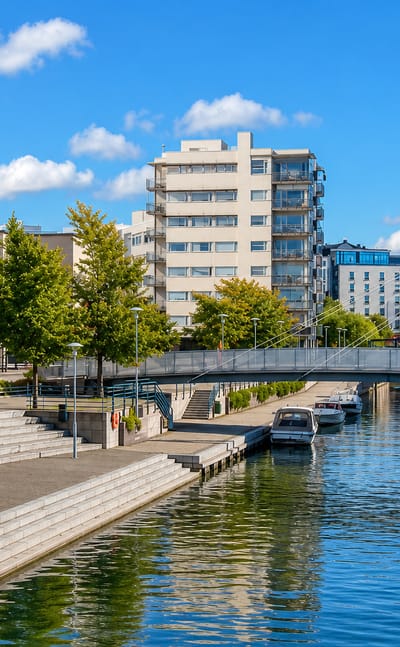 Ruoholahti canal in Helsinki with its cable-stayed footbridge, moored boats and waterfront apartment blocks