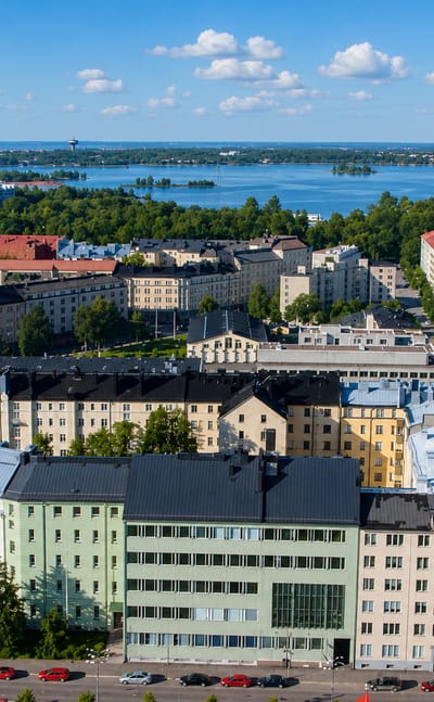 Aerial view of Töölö's apartment blocks and church spire beside the bay in Helsinki.
