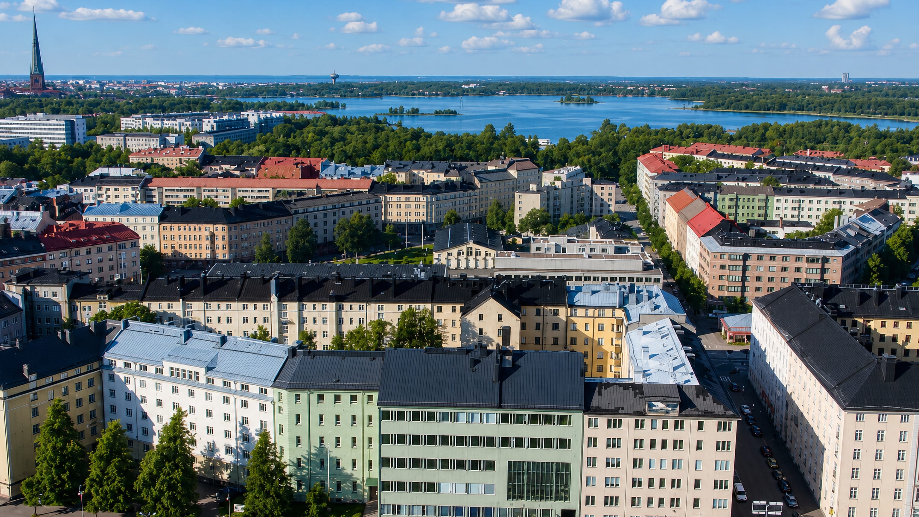 Aerial view of Töölö's apartment blocks and church spire beside the bay in Helsinki.