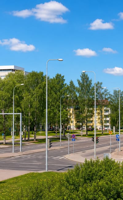 Tree-lined suburban boulevard with modern and 1960s apartment blocks in Vartiokylä, eastern Helsinki.