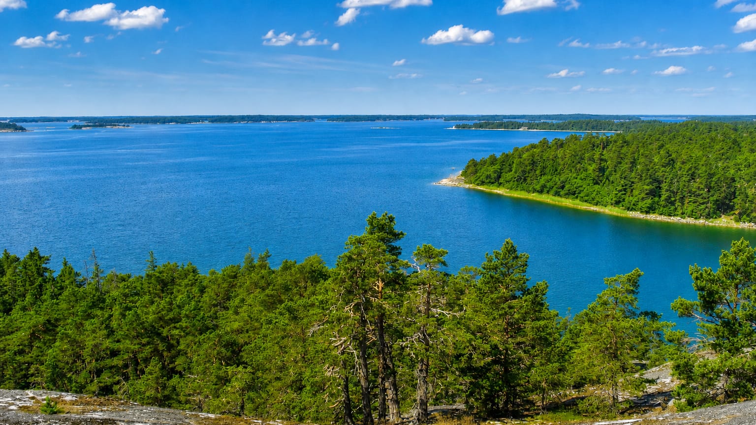 Forested rocky islets and open blue waters of Iniö in Finland's Archipelago Sea on a clear summer day