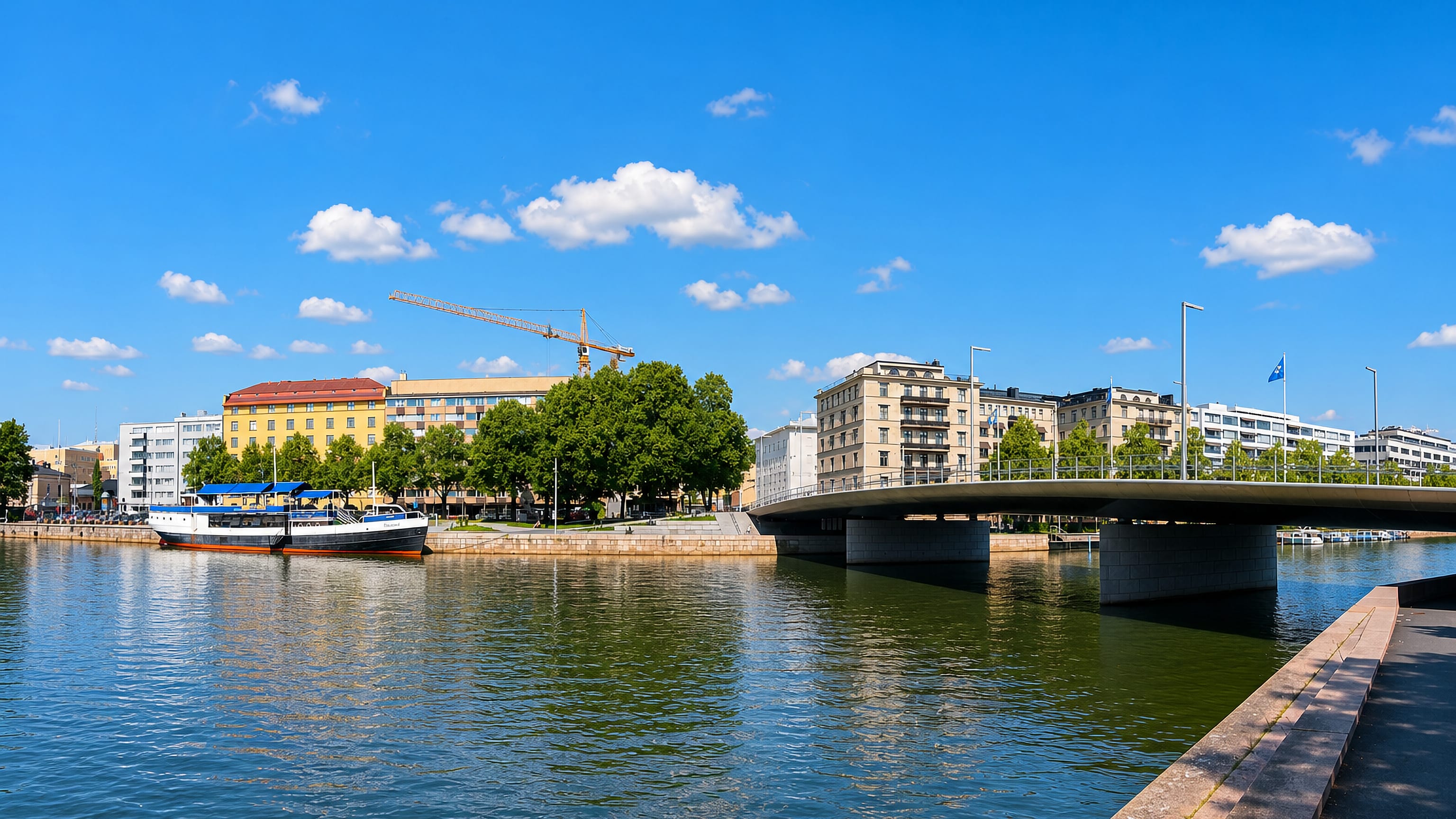 Moored ship and a road bridge on the Aura River beside the VII kaupunginosa district of Turku.