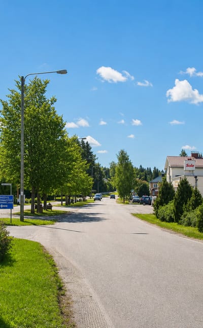 Village roadside with a Sale grocery and ABC service station beside a tree-lined road in Yläne, Finland.