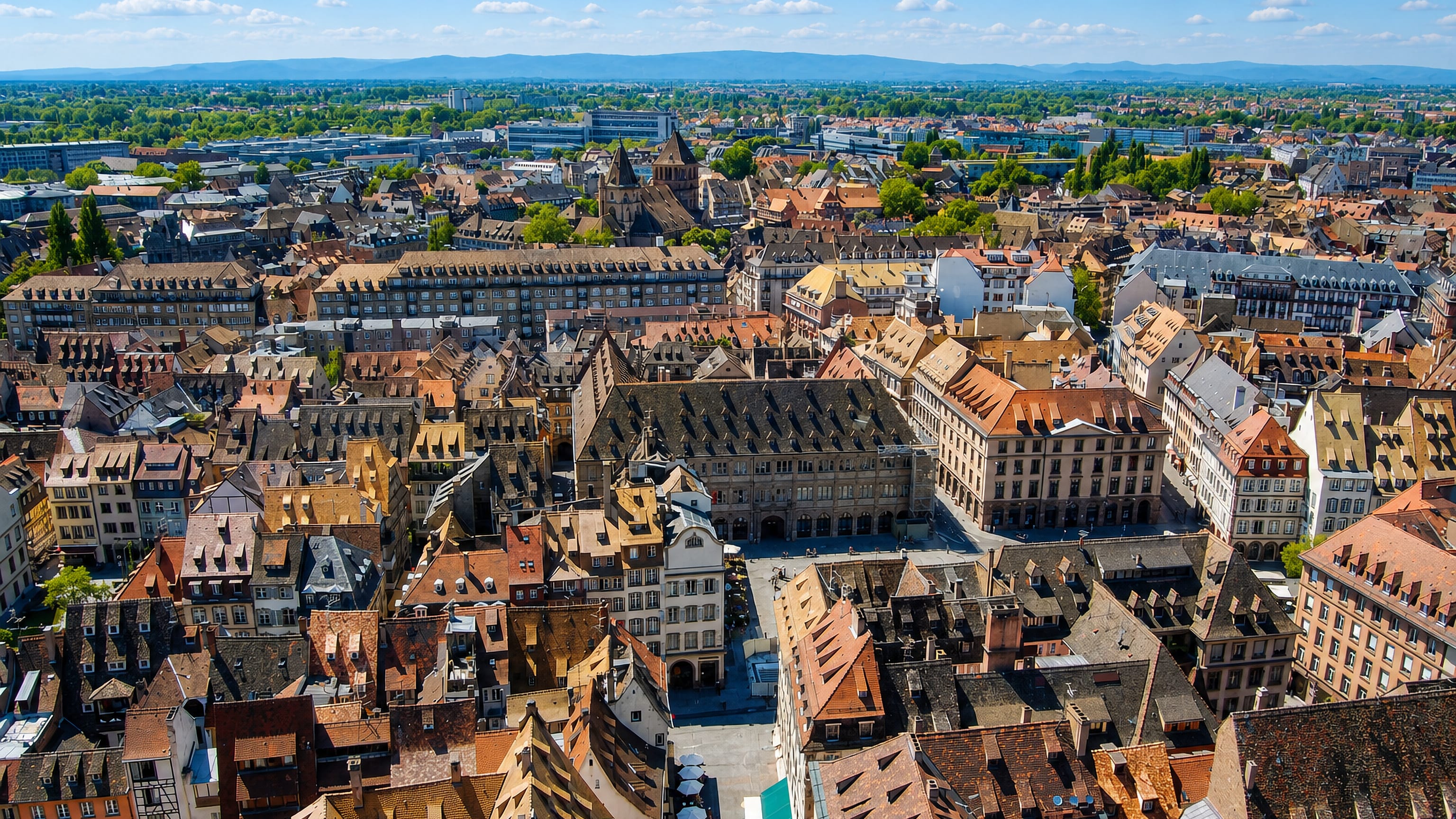 Aerial view over the tiled rooftops and squares of the Grande Ile, Strasbourg's old town.