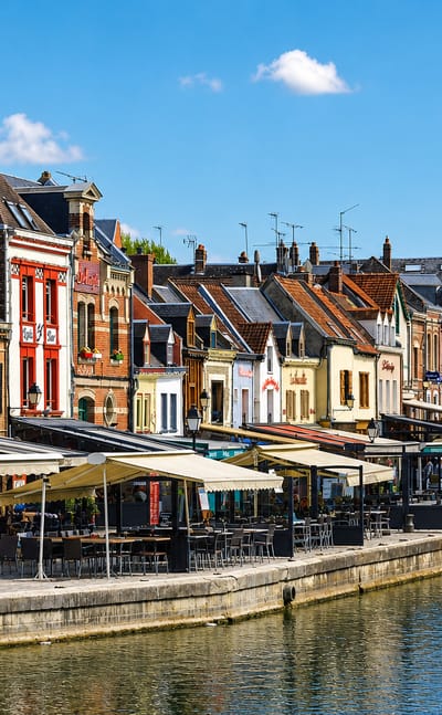 Colourful canalside houses and quayside restaurants along the Somme in the Saint-Leu quarter of Amiens.