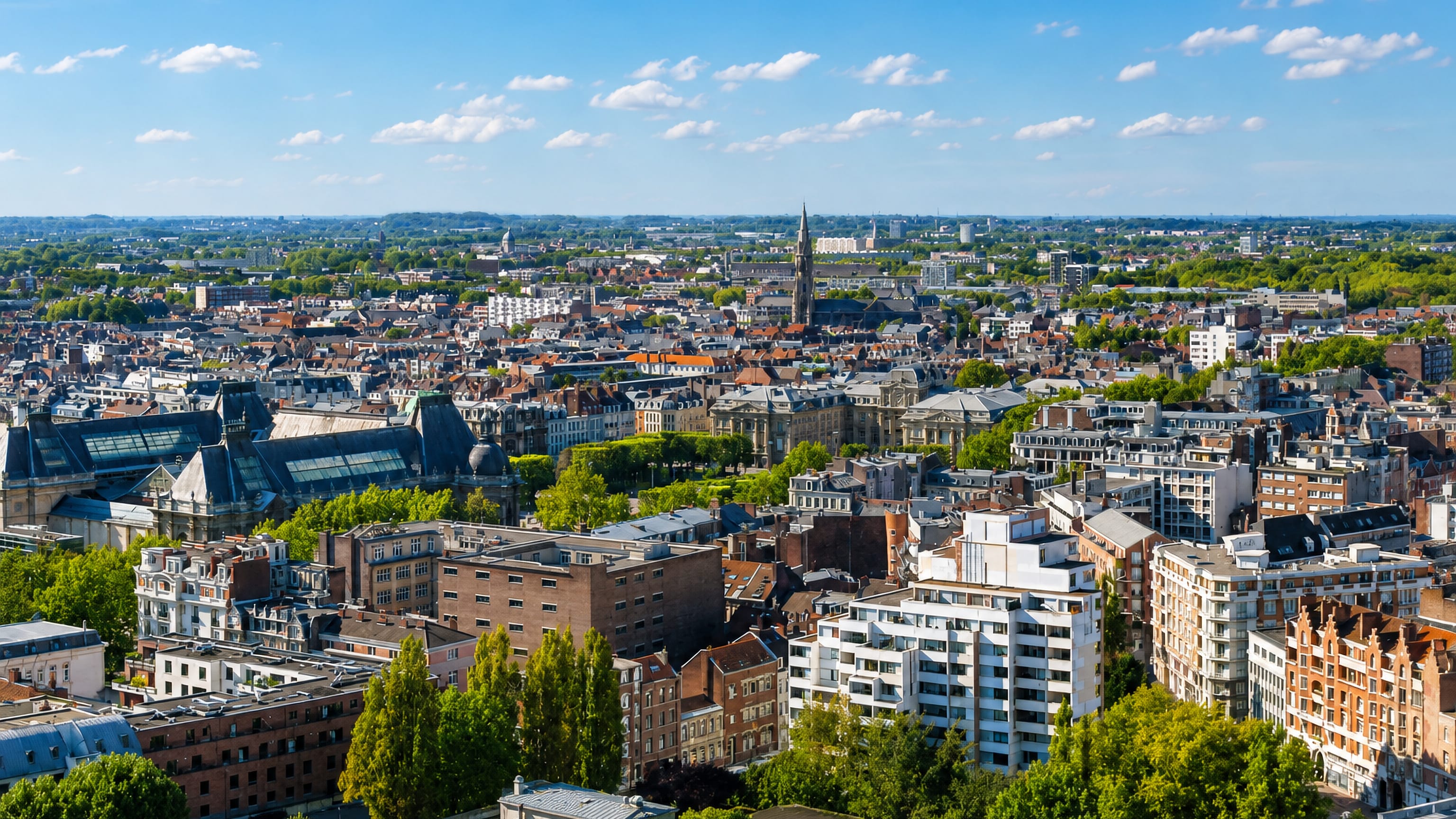 Elevated view over Lille's rooftops toward a gothic church spire amid Flemish facades and modern blocks.