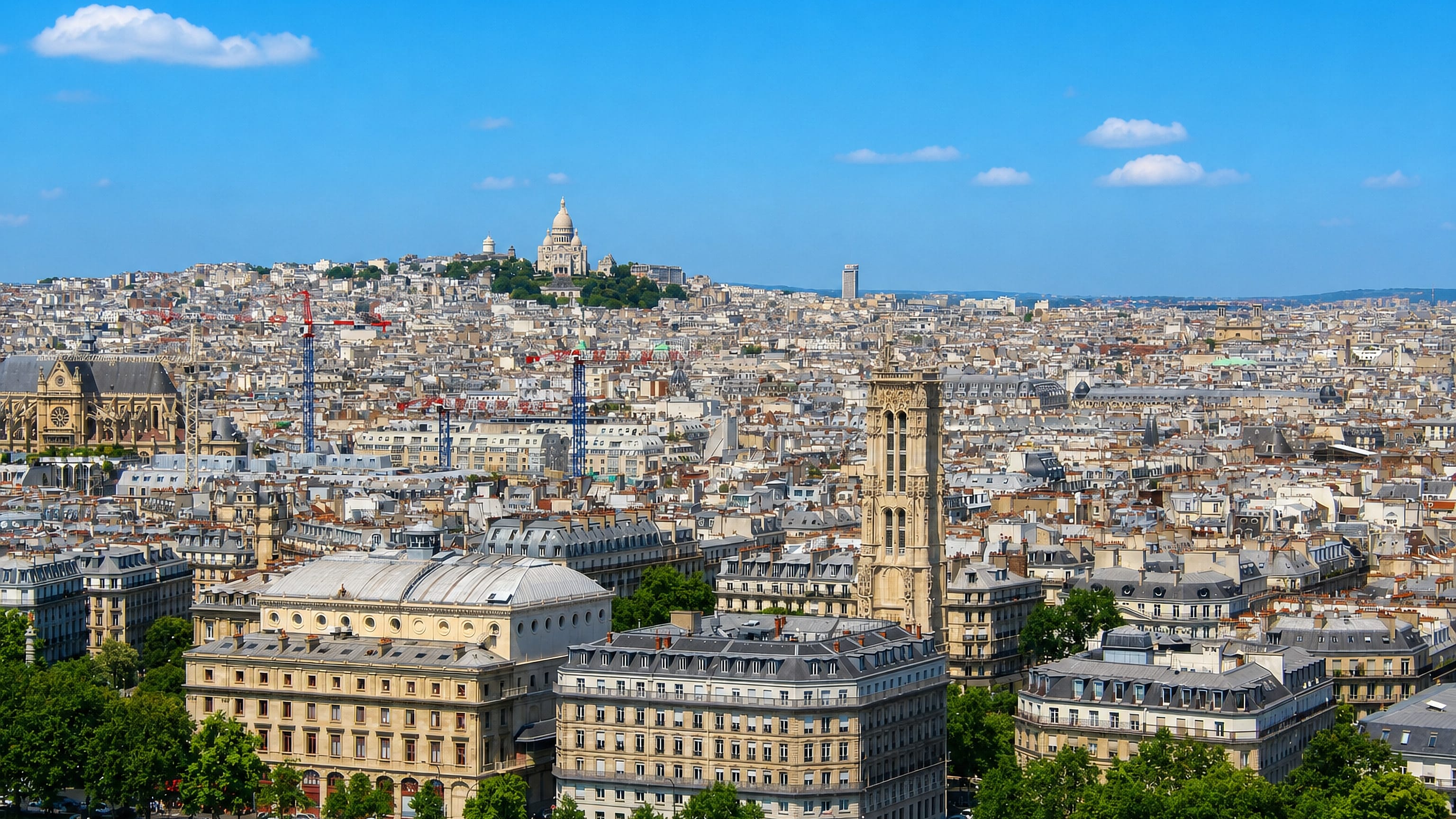 Paris rooftops rising to the butte of Montmartre, crowned by the white domes of Sacre-Coeur basilica