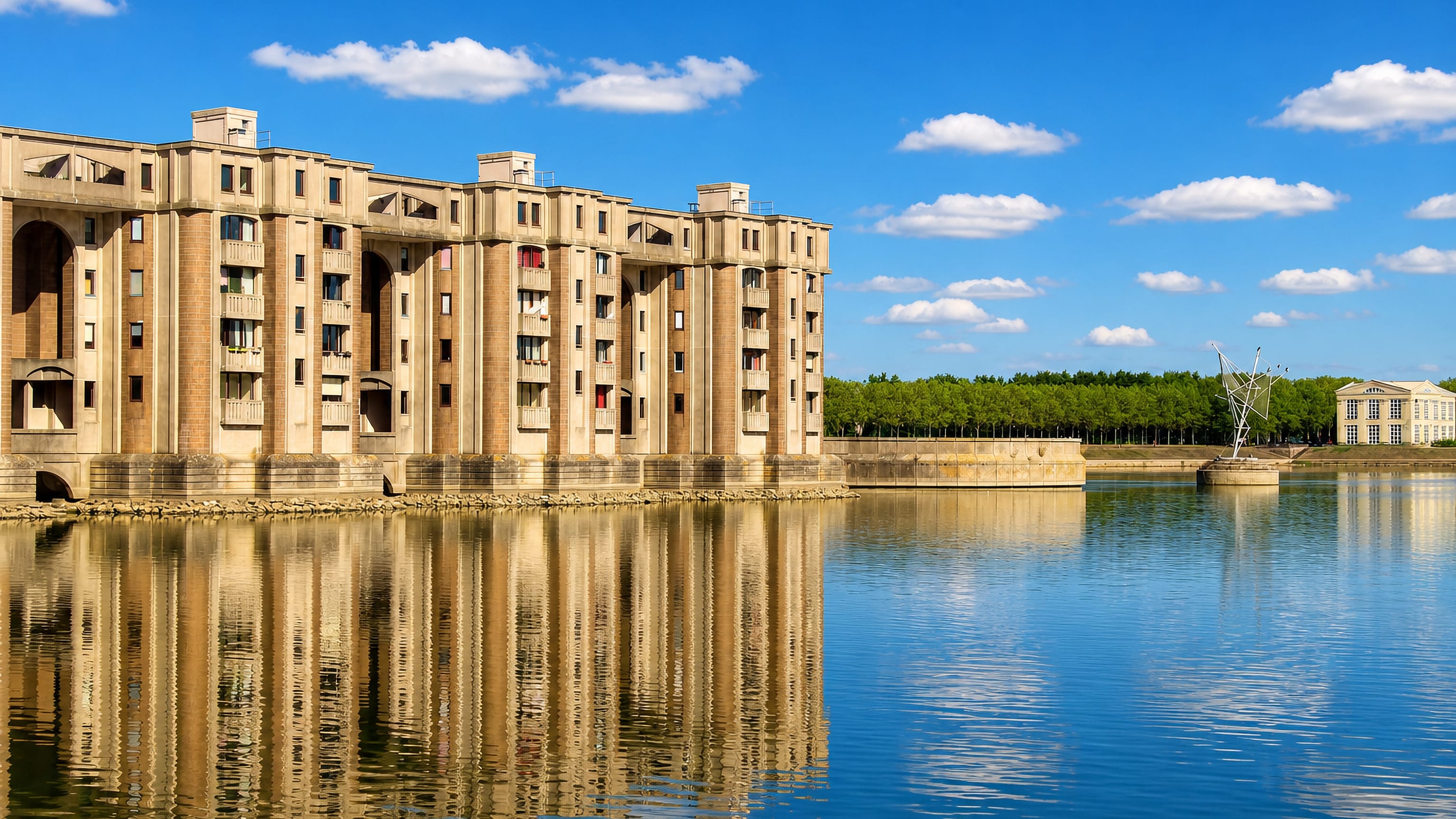 Postmodern colonnaded housing block rising from the lake at Saint-Quentin-en-Yvelines, France.