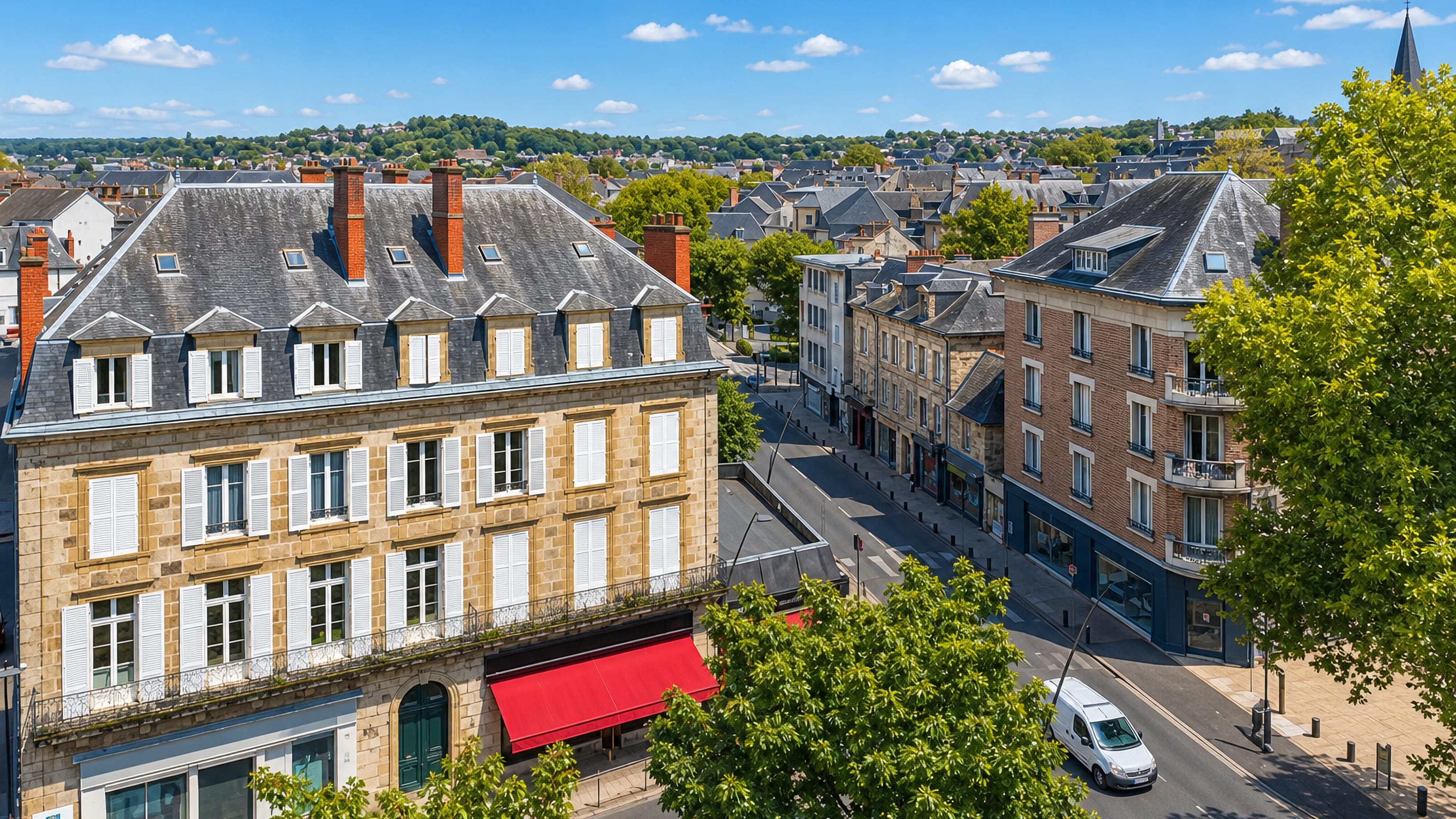 Limestone townhouses with slate roofs lining a sunlit boulevard in Brive-la-Gaillarde, southwestern France.